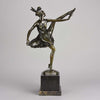 High Kick by Bruno Zach an Antique Bronze Figure of an energetic dancer with her leg raised high. The surface of the bronze with excellent deep rich colour and very fine hand finished detail, raised on a marble base  