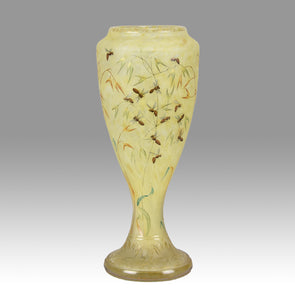 Bees and Flowers Vase by Daum Frères a late 19th Century French cameo glass vase etched and enamelled with a hive of bees pollinating flowers against a pale yellow field