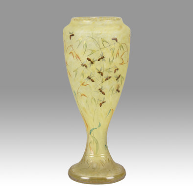 Bees and Flowers Vase by Daum Frères a late 19th Century French cameo glass vase etched and enamelled with a hive of bees pollinating flowers against a pale yellow field