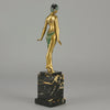 Alexandrian Dancer by Demetre Chiparus A fabulous Art Deco gilt bronze figure of a beautiful Egyptian dancer in full dance costume with her arms held by her sides, hand finished in stunning gilded and cold painted enamel colour, raised on a portoro marble base