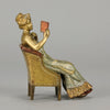 Lady Reading by Franz Bergman an attractive early 20th Century Austrian bronze study of a seated lady wearing a loosley fitted night dress reading a book, her dress lifting to reveal her beautiful body