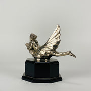 Wave rider Car bonnet mascot by Georges Delperier  in the form of a winged woman laying on her front in a casual pose riding on top of a wave, with very fine hand finished detail. Raised on an octagonal wooden plinth