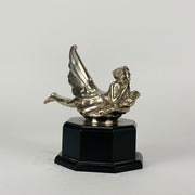 Wave rider Car bonnet mascot by Georges Delperier  in the form of a winged woman laying on her front in a casual pose riding on top of a wave, with very fine hand finished detail. Raised on an octagonal wooden plinth
