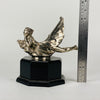 Wave rider Car bonnet mascot by Georges Delperier  in the form of a winged woman laying on her front in a casual pose riding on top of a wave, with very fine hand finished detail. Raised on an octagonal wooden plinth