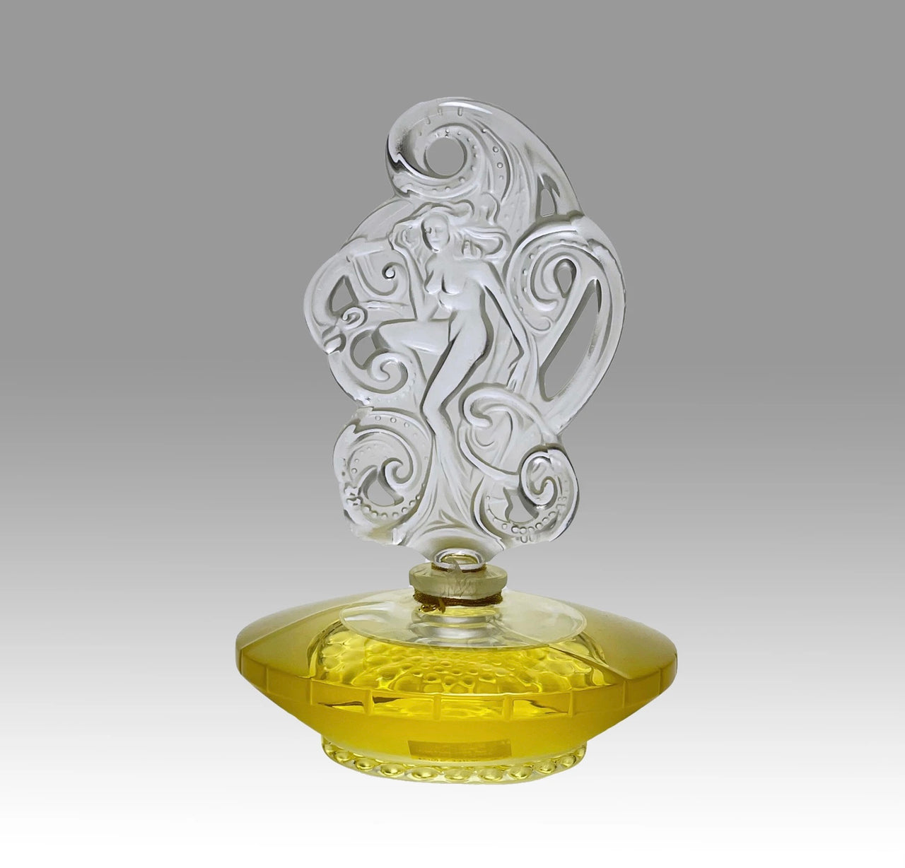 Songe Perfume bottle by Marie Claude Lalique An attractive limited edition clear and frosted glass scent bottle, the clear glass body containing the original Lalique perfume complete with a large frosted stopper, depicting a nude among waves - Hickmet Fine Arts