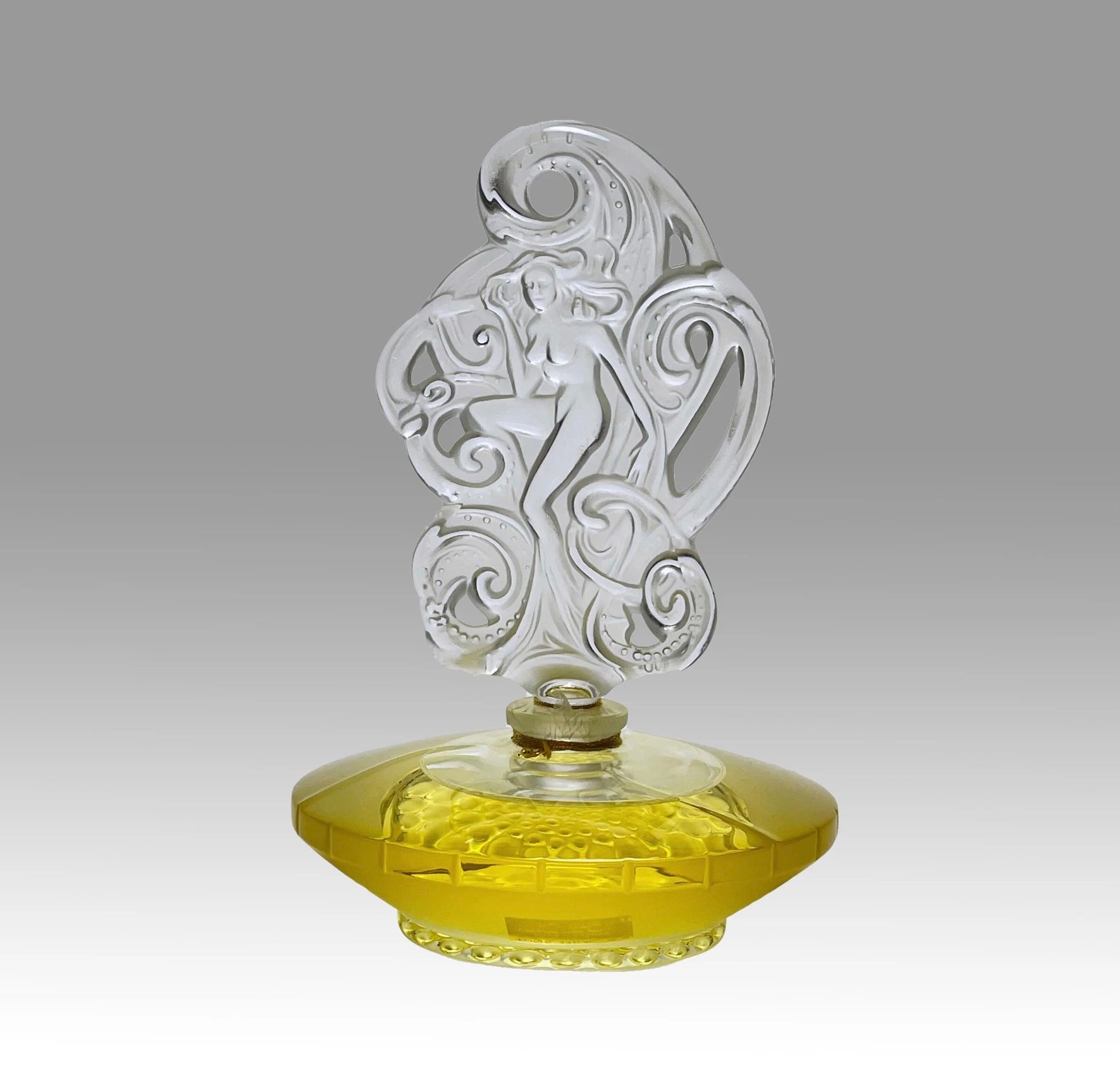 Songe Perfume bottle by Marie Claude Lalique An attractive limited edition clear and frosted glass scent bottle, the clear glass body containing the original Lalique perfume complete with a large frosted stopper, depicting a nude among waves - Hickmet Fine Arts