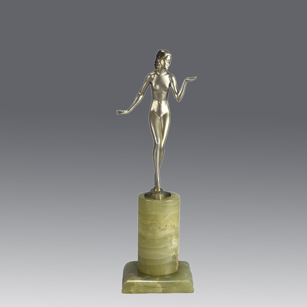 Art Deco Lady by Adolph in a questioning pose with one hand out, signed Adolph and raised on a tall cylindrical Brazilian green onyx base