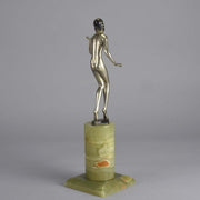 Art Deco Lady by Adolph in a questioning pose with one hand out, signed Adolph and raised on a tall cylindrical Brazilian green onyx base