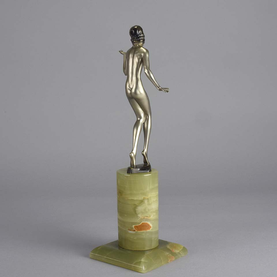 Art Deco Lady by Adolph in a questioning pose with one hand out, signed Adolph and raised on a tall cylindrical Brazilian green onyx base