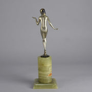 Art Deco Lady by Adolph in a questioning pose with one hand out, signed Adolph and raised on a tall cylindrical Brazilian green onyx base