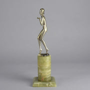Art Deco Lady by Adolph in a questioning pose with one hand out, signed Adolph and raised on a tall cylindrical Brazilian green onyx base