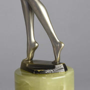 Art Deco Lady by Adolph in a questioning pose with one hand out, signed Adolph and raised on a tall cylindrical Brazilian green onyx base
