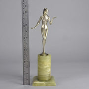 Art Deco Lady by Adolph in a questioning pose with one hand out, signed Adolph and raised on a tall cylindrical Brazilian green onyx base