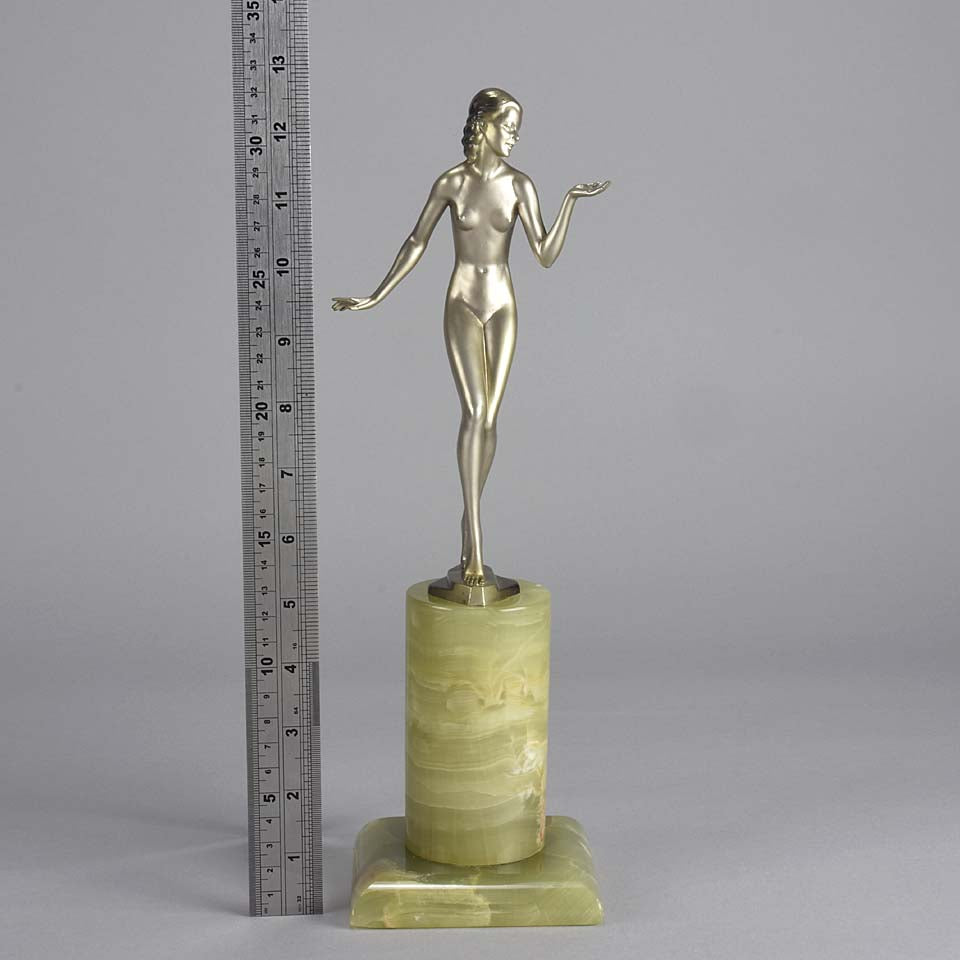 Art Deco Lady by Adolph in a questioning pose with one hand out, signed Adolph and raised on a tall cylindrical Brazilian green onyx base