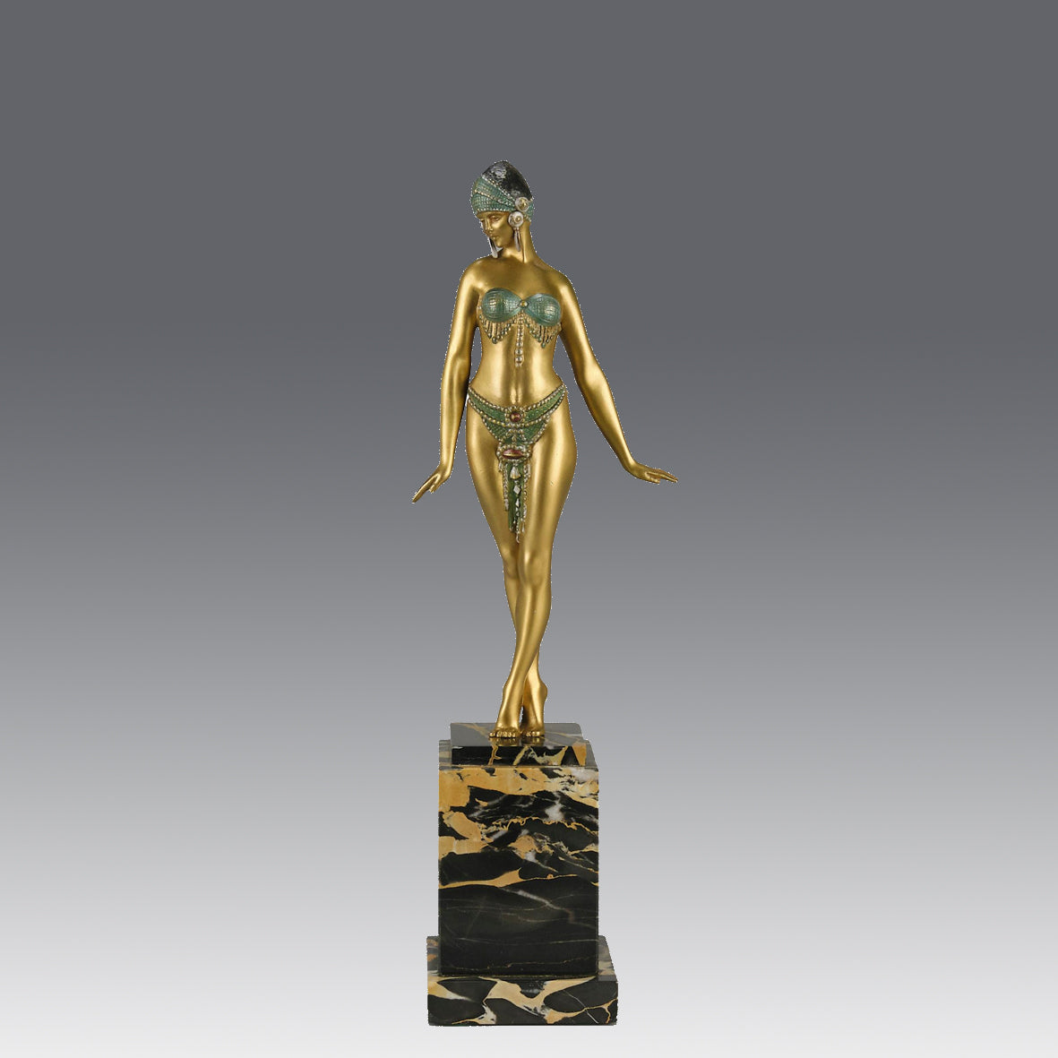 Alexandrian Dancer by Demetre Chiparus A fabulous Art Deco gilt bronze figure of a beautiful Egyptian dancer in full dance costume with her arms held by her sides, hand finished in stunning gilded and cold painted enamel colour, raised on a portoro marble base