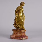 An antique bronze figure of an Art Nouveau Lady a gilt bronze figure of a very beautiful lady, her diaphonous clothing seductively draped over her body 