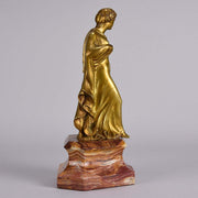 An antique bronze figure of an Art Nouveau Lady a gilt bronze figure of a very beautiful lady, her diaphonous clothing seductively draped over her body 