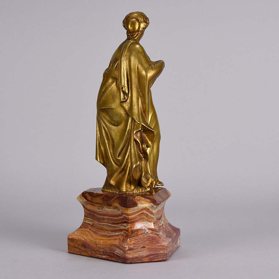 An antique bronze figure of an Art Nouveau Lady a gilt bronze figure of a very beautiful lady, her diaphonous clothing seductively draped over her body 