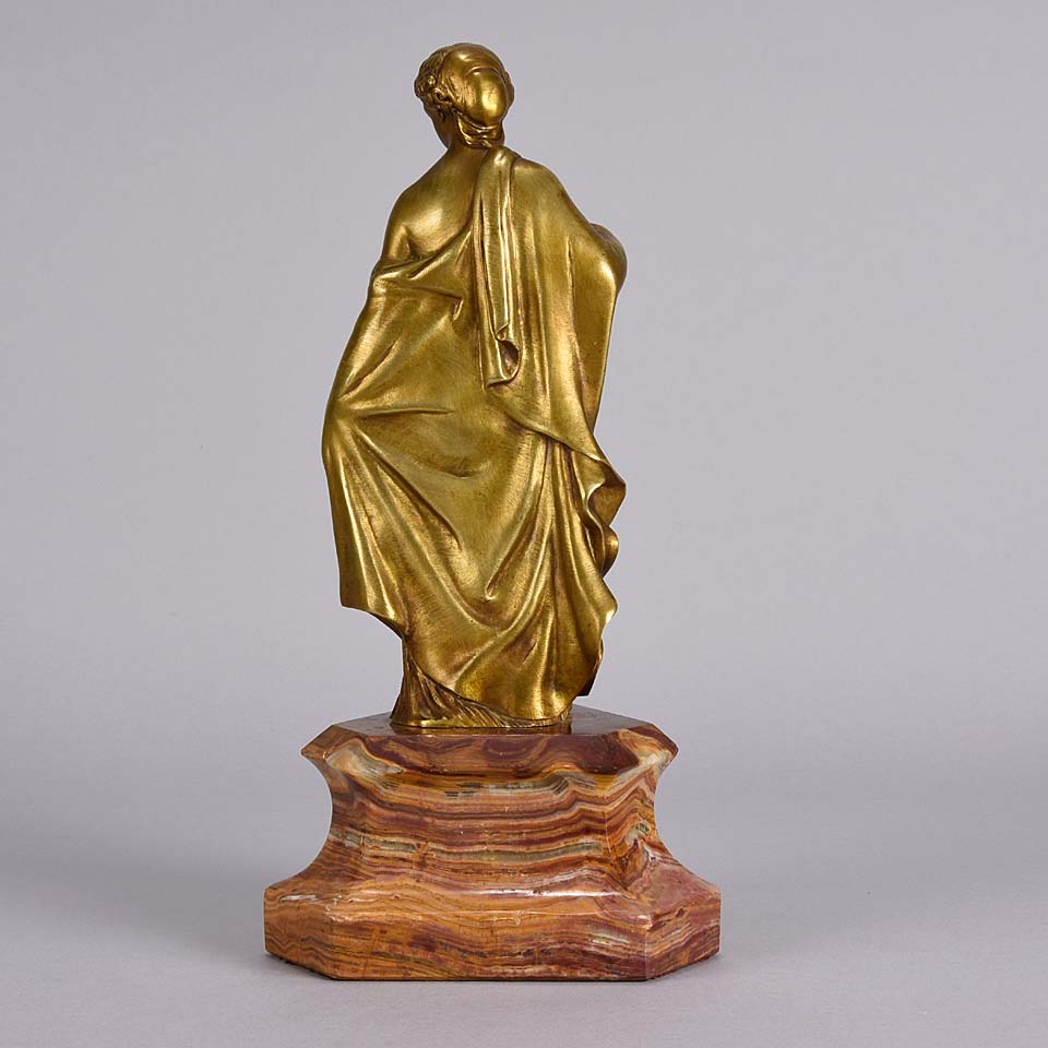 An antique bronze figure of an Art Nouveau Lady a gilt bronze figure of a very beautiful lady, her diaphonous clothing seductively draped over her body 