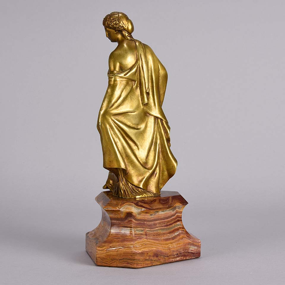 An antique bronze figure of an Art Nouveau Lady a gilt bronze figure of a very beautiful lady, her diaphonous clothing seductively draped over her body 