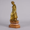 An antique bronze figure of an Art Nouveau Lady a gilt bronze figure of a very beautiful lady, her diaphonous clothing seductively draped over her body 