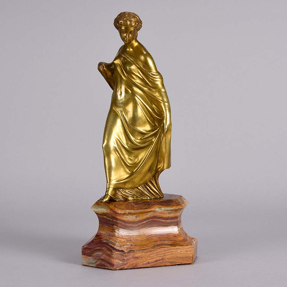 An antique bronze figure of an Art Nouveau Lady a gilt bronze figure of a very beautiful lady, her diaphonous clothing seductively draped over her body 