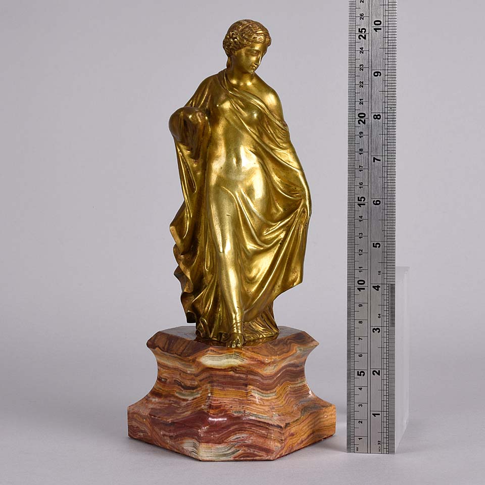 An antique bronze figure of an Art Nouveau Lady a gilt bronze figure of a very beautiful lady, her diaphonous clothing seductively draped over her body 
