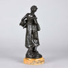 Autumn an antique bronze figure by Auguste Moreau a figure of a young farm girl carrying a laden basket with very fine colour and excellent had finished surface detail, raised on a marble base 