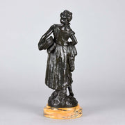 Autumn an antique bronze figure by Auguste Moreau a figure of a young farm girl carrying a laden basket with very fine colour and excellent had finished surface detail, raised on a marble base 