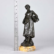 Autumn an antique bronze figure by Auguste Moreau a figure of a young farm girl carrying a laden basket with very fine colour and excellent had finished surface detail, raised on a marble base 