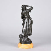Summer by Auguste Moreau an antique bronze figure of a young girl in period clothing carrying an arm full of fruits with a basket full by her side, with excellent surface detail 