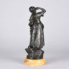 Summer by Auguste Moreau an antique bronze figure of a young girl in period clothing carrying an arm full of fruits with a basket full by her side, with excellent surface detail 