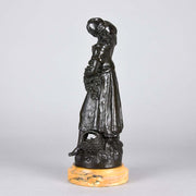 Summer by Auguste Moreau an antique bronze figure of a young girl in period clothing carrying an arm full of fruits with a basket full by her side, with excellent surface detail 