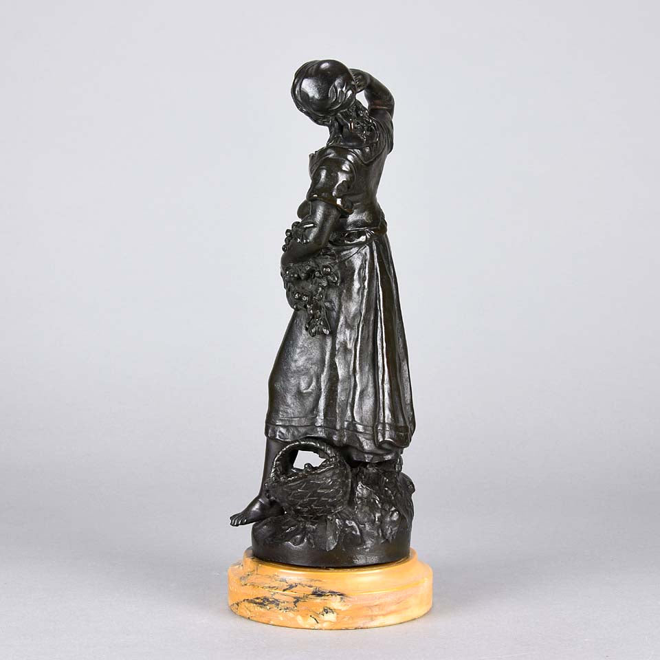 Summer by Auguste Moreau an antique bronze figure of a young girl in period clothing carrying an arm full of fruits with a basket full by her side, with excellent surface detail 