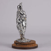 Bagpipes Car Bonet Mascot in the form of a Scotsman dressed in a kilt playing the bagpipes. Exhibiting a well polished surface and fine hand finished detail it is raised and fitted on a stepped circular stand