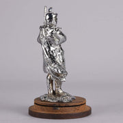 Bagpipes Car Bonet Mascot in the form of a Scotsman dressed in a kilt playing the bagpipes. Exhibiting a well polished surface and fine hand finished detail it is raised and fitted on a stepped circular stand