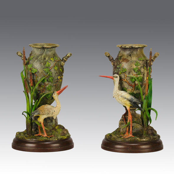 A Pair of Bird Vases by Franz Bergman decorated with Ibis standing amongst bulrush raised on a naturalistic bases with very fine colours and good hand finished surface detail 