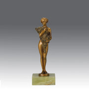 The Bouquet by Joseph Lorenzl an elegant early 20th Century Art Deco cold painted bronze figure of a young beauty holding a large bouquet of flowers covering her modesty raised on a green onyx base 