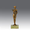 The Bouquet by Joseph Lorenzl an elegant early 20th Century Art Deco cold painted bronze figure of a young beauty holding a large bouquet of flowers covering her modesty raised on a green onyx base 