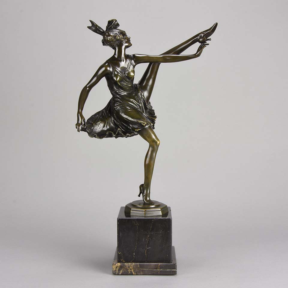 High Kick by Bruno Zach an Antique Bronze Figure of an energetic dancer with her leg raised high. The surface of the bronze with excellent deep rich colour and very fine hand finished detail, raised on a marble base  
