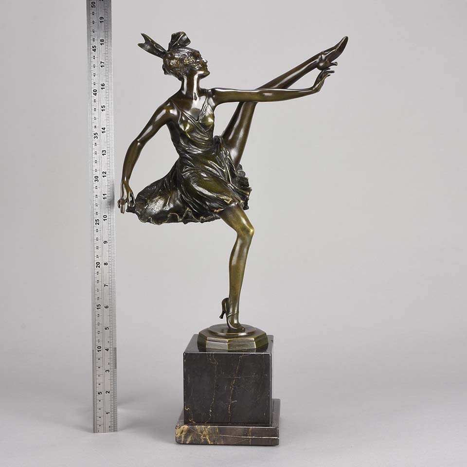 High Kick by Bruno Zach an Antique Bronze Figure of an energetic dancer with her leg raised high. The surface of the bronze with excellent deep rich colour and very fine hand finished detail, raised on a marble base  
