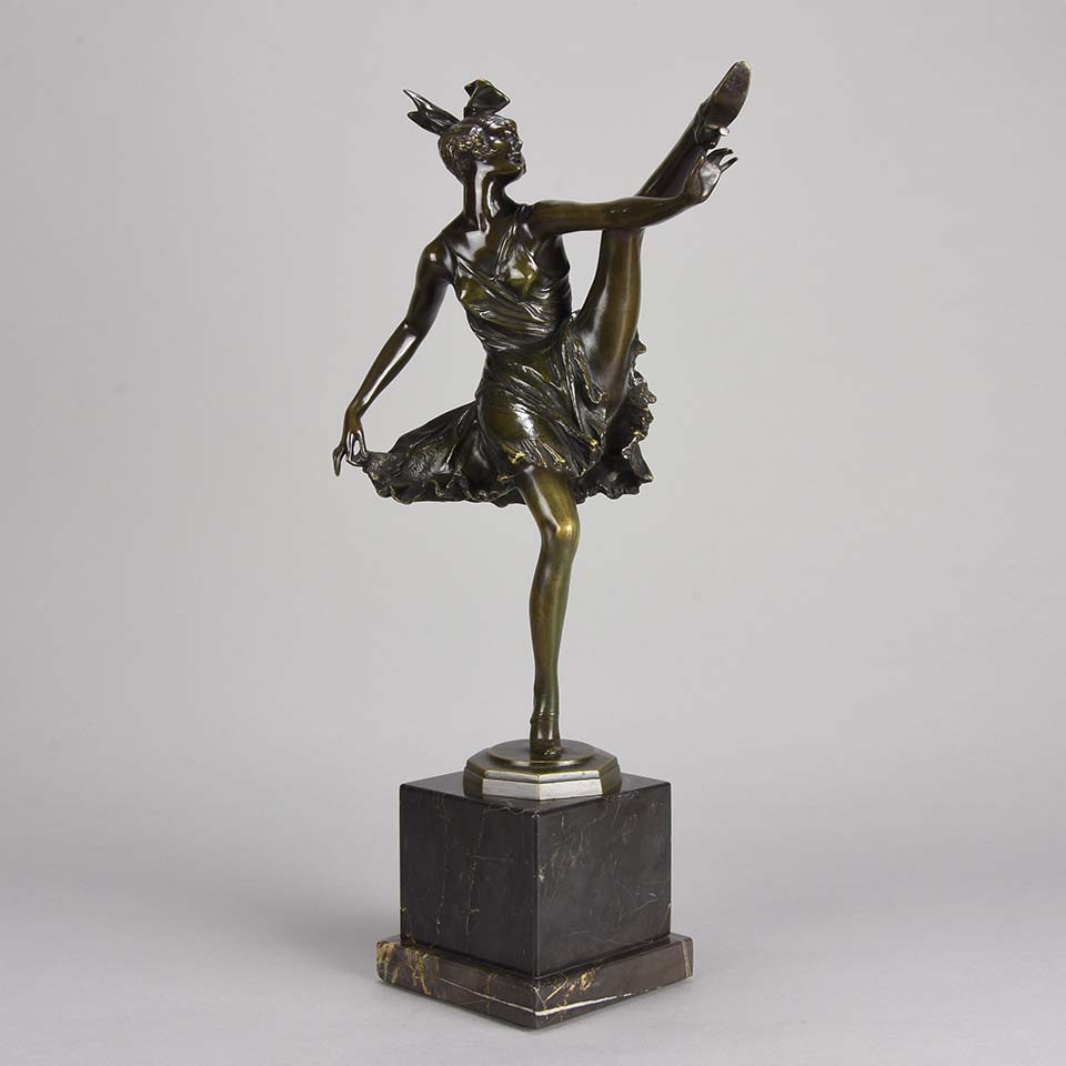 High Kick by Bruno Zach an Antique Bronze Figure of an energetic dancer with her leg raised high. The surface of the bronze with excellent deep rich colour and very fine hand finished detail, raised on a marble base  