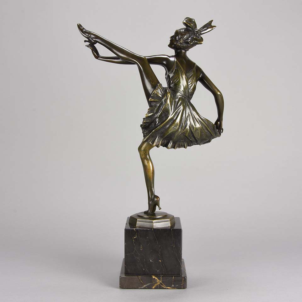 High Kick by Bruno Zach an Antique Bronze Figure of an energetic dancer with her leg raised high. The surface of the bronze with excellent deep rich colour and very fine hand finished detail, raised on a marble base  