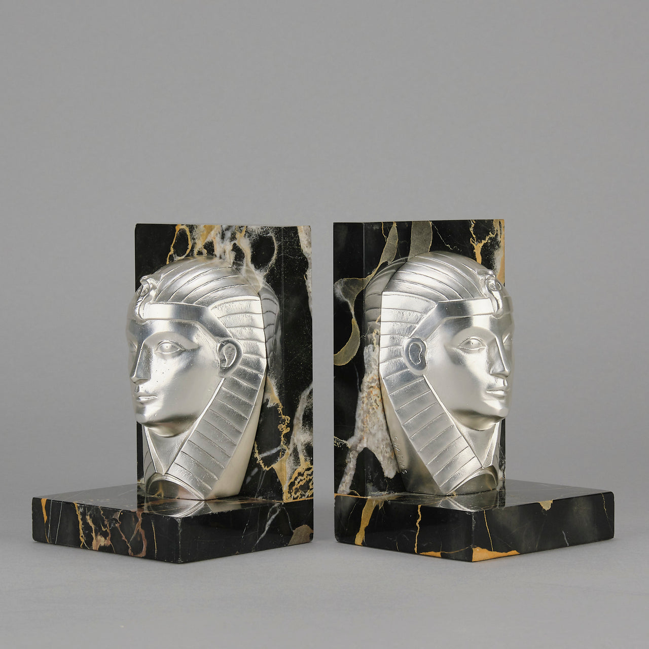 Art Deco silvered bronze bookends in the form of two Pharoah heads mounted on marble bases by Charles Charles - Hickmet Fine Arts