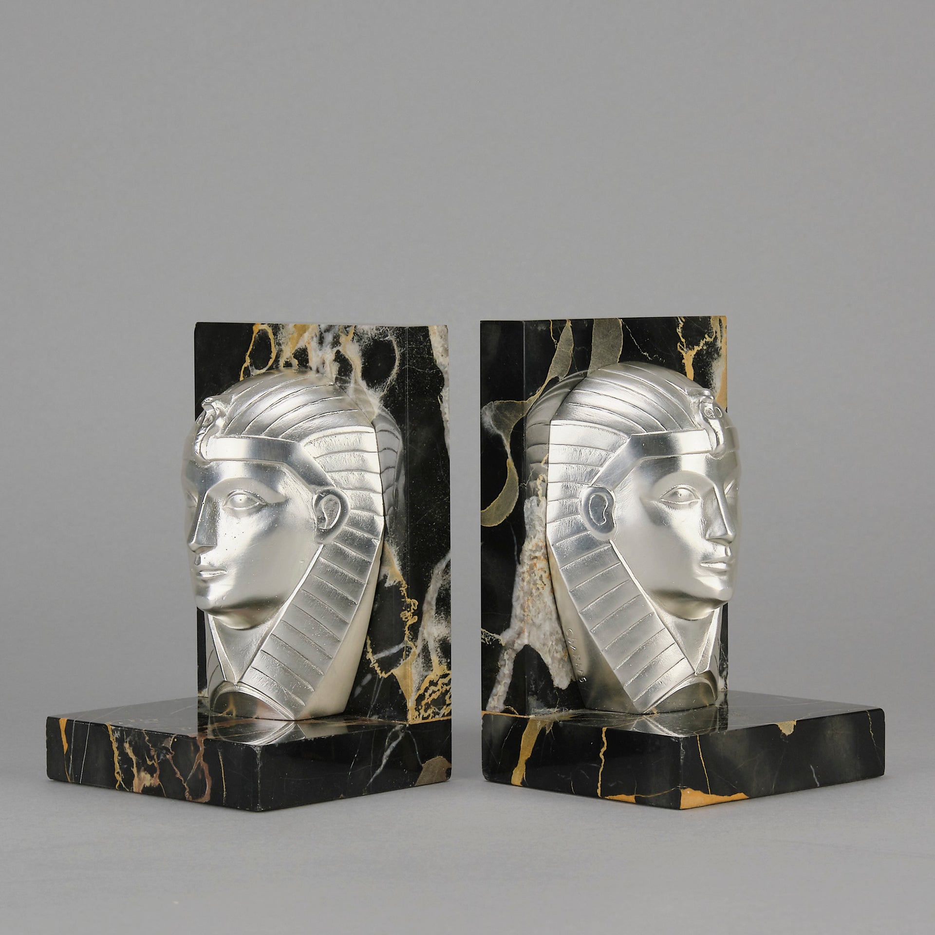 Art Deco silvered bronze bookends in the form of two Pharoah heads mounted on marble bases by Charles Charles - Hickmet Fine Arts