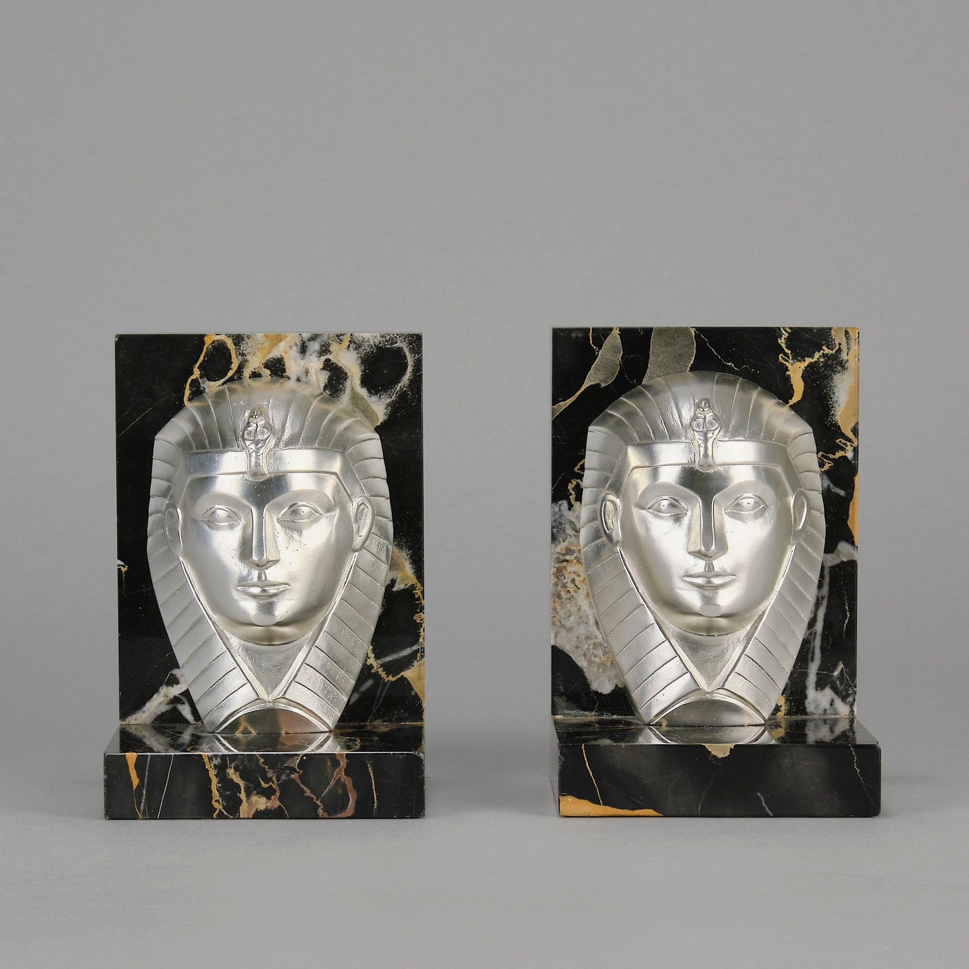 Art Deco silvered bronze bookends in the form of two Pharoah heads mounted on marble bases by Charles Charles - Hickmet Fine Arts