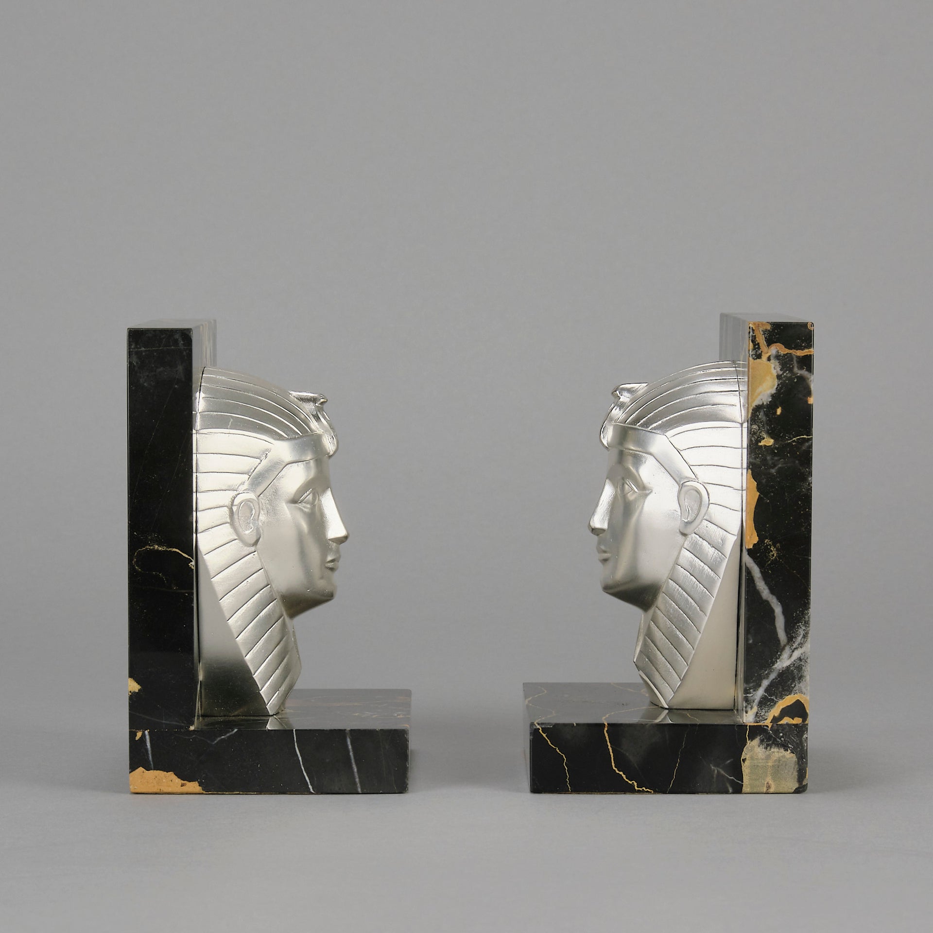 Art Deco silvered bronze bookends in the form of two Pharoah heads mounted on marble bases by Charles Charles - Hickmet Fine Arts
