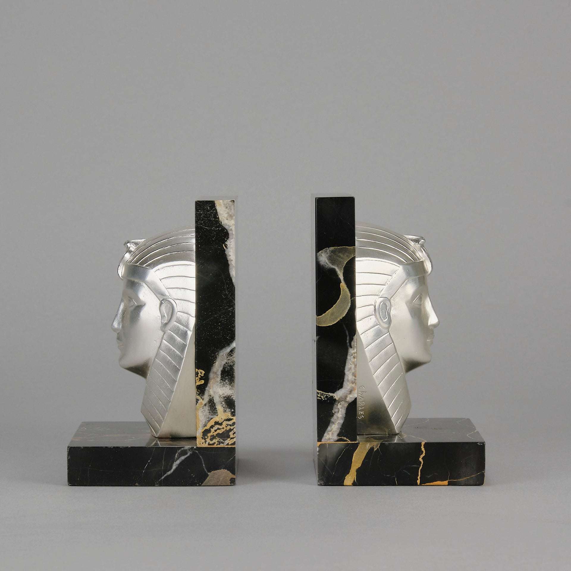 Art Deco silvered bronze bookends in the form of two Pharoah heads mounted on marble bases by Charles Charles - Hickmet Fine Arts