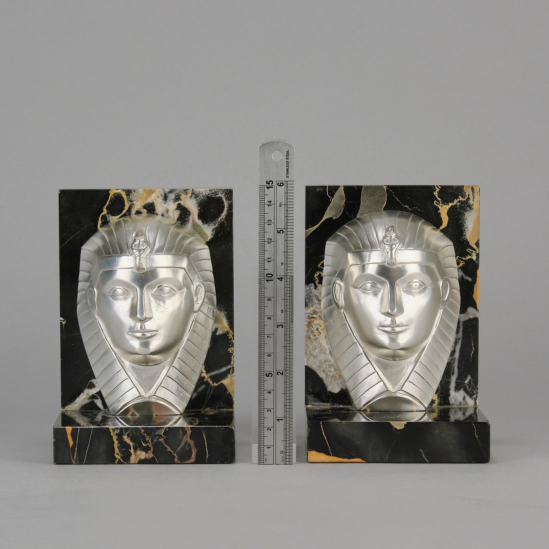 Art Deco silvered bronze bookends in the form of two Pharoah heads mounted on marble bases by Charles Charles - Hickmet Fine Arts