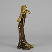 Jeune Femme by C Peyre A very fine Art Nouveau bronze study of a young beauty in coy pose, clothed in a long flowing skirt, her head and arms in gilt bronze to contrast with the rich brown colour of her clothes